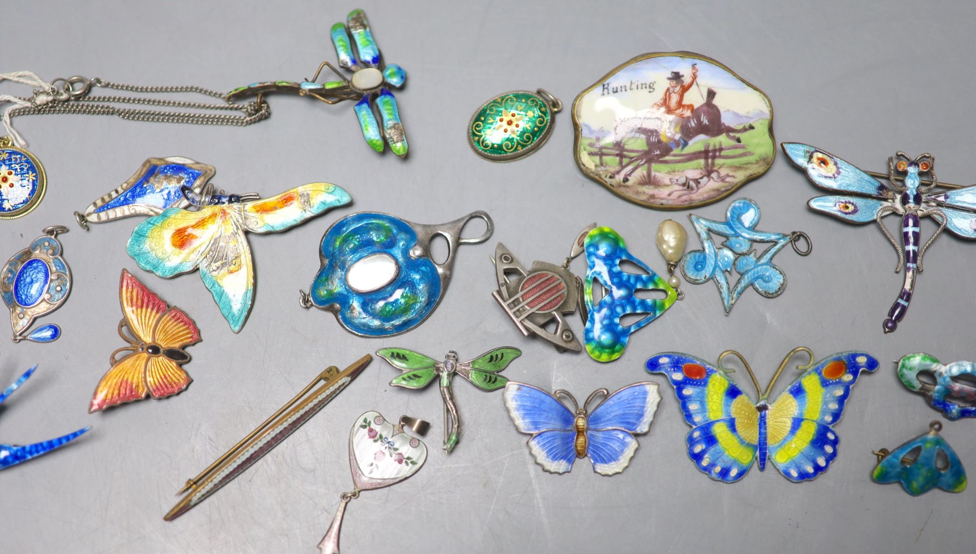 A mixed group of enamelled jewellery.